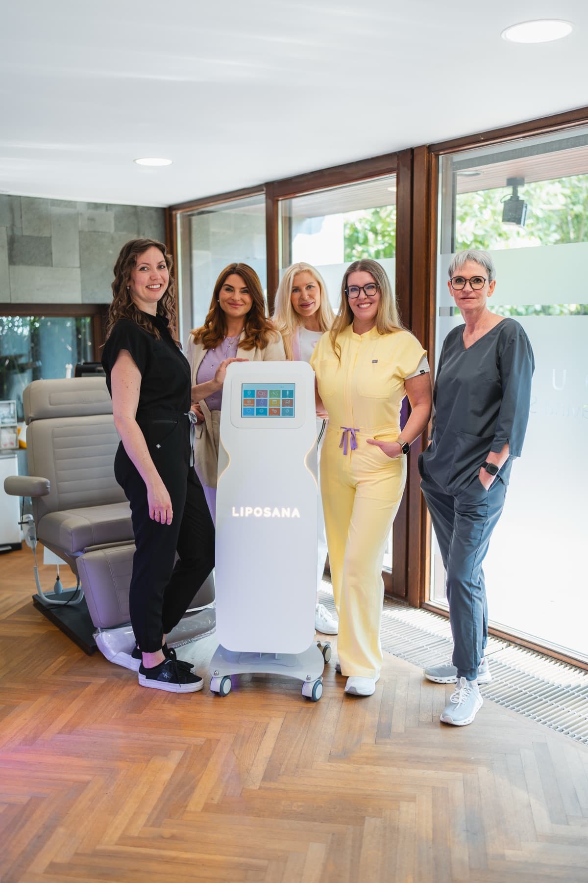 Fünf Frauen stehen lächelnd um das LIPOSANA3® NEO System